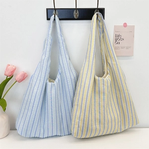 Detail of colorful striped canvas tote bags with wide shoulder straps in ins style