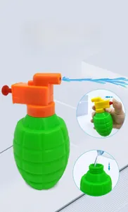 Macro detail of grenade-shaped squirt gun toy showing water filling and spray action
