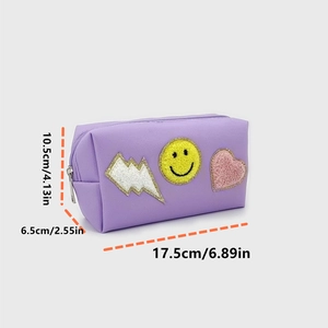 Detail of purple PU cosmetic bag with towel embroidery lightning, smile, and heart patches