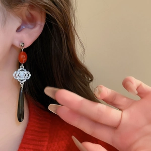 Vintage Chinese knot earrings with faux agate water drop tassels on female model