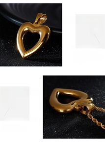 Detailed macro of gold heart pendant and rope chain with polished mirror finish