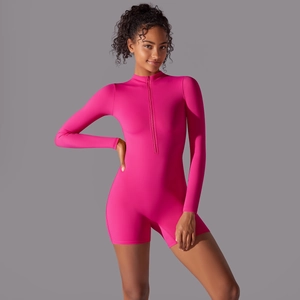 Close-up of rose pink athletic bodysuit showing zipper detail and stretch fabric
