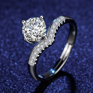Detailed view of silver-tone zircon ring with wavy pavé band on a dark blue background