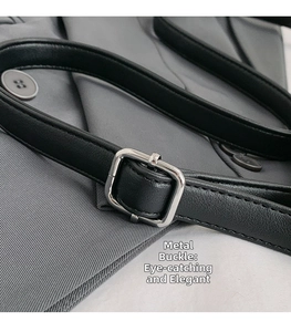 Detailed macro view of the black leather strap with a silver square metal buckle