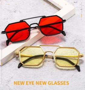 Detail view of octagon metal sunglasses with dual bridge and colorful tinted lenses