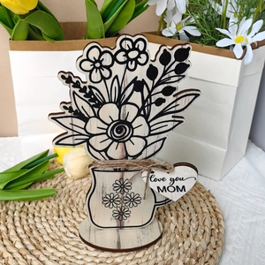 Detail of wooden flower ornament with laser engraving and Love You Mom heart tag