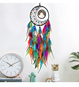 Detail of tree of life dreamcatcher with colorful feathers and moon charm home decor