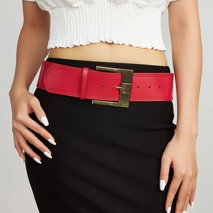 Vintage red leather wide belt with antique gold buckle styled on a waist