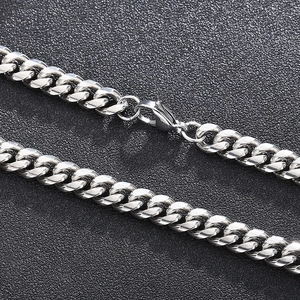 Close-up of silver titanium steel Cuban link chain with a secure lobster clasp