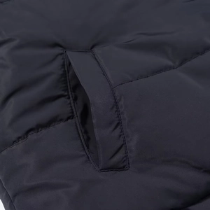 Close-up of the diagonal pocket detail on a black reversible puffer jacket