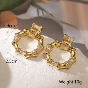 Detailed view of bamboo-shaped gold earrings with zircon inlay and size dimensions