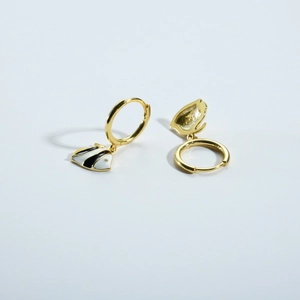 Macro detail of S925 silver tropical fish earrings with black enamel and gold finish