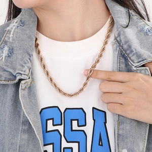 Close-up of rose gold twist rope chain necklace worn by a model for a hip-hop trendy style