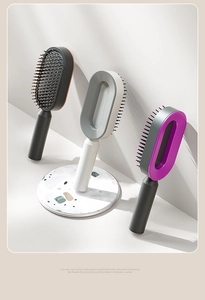 Close-up of three-piece air cushion hairbrush set in black, white, and purple finishes