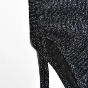 Detail of black shimmering fabric with metallic texture and drawstring strap design