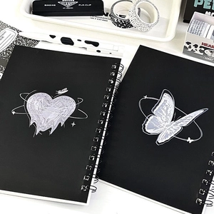 Detail of A5 spiral notebooks featuring black covers with Y2K heart and butterfly prints