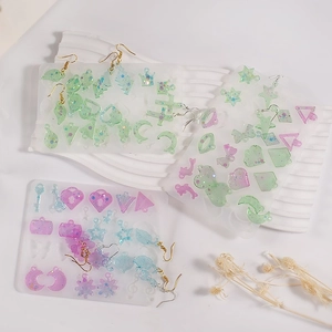 Macro shot of resin earring charms and silicone molds in heart and moon shapes