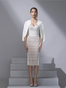 Detail of white slim fit ruched dress with matching cropped knit cardigan on a model