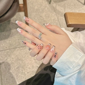 Polka dot and pearl press-on nails with 3D floral accents in french elegant style