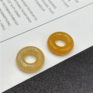 Close-up of translucent amber stone donut beads with natural jade-like texture and finish