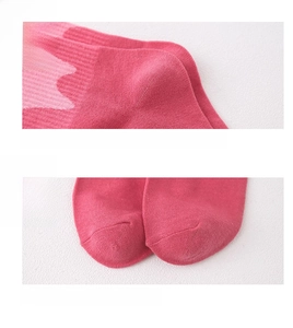 Detail of pink knitted socks showing reinforced anti-wear heel and seamless toe design