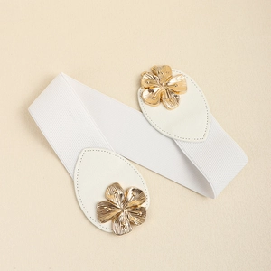 Detailed view of white elastic belt with gold floral metal buckle and leather ends