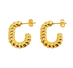 Macro view of gold twisted croissant hoop earrings with a high-polished mirror finish