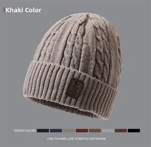 Detail of khaki cable knit beanie with premium leather label and multi-color options