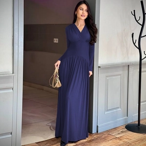Detail view of navy blue V-neck maxi dress with long sleeves and pleated waist design