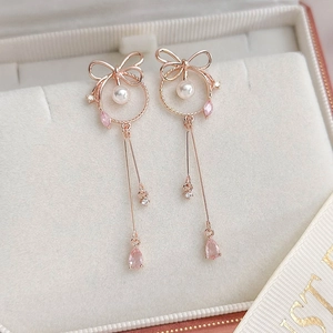 Detail of rose gold butterfly earring with pearl and pink teardrop gemstone
