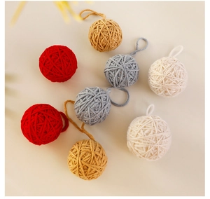 Detailed view of assorted knitted wool Christmas balls in neutral and festive colors