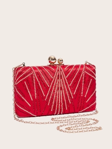 Close-up of red evening clutch bag with gold geometric beadwork and metal chain strap