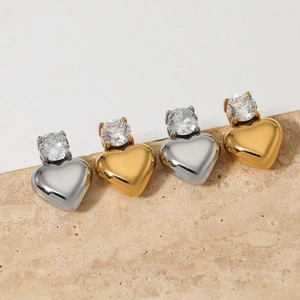 Elegant gold and silver heart stud earrings with sparkling cubic zirconia on stone base