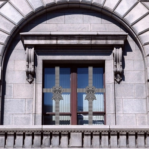 Detail of black and white gingham ribbon bows decorating a classical stone window