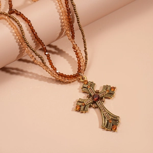 Vintage multi-layer beaded necklace with bronze cross pendant and sparkling rhinestones