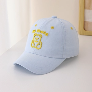 Close-up of light blue kids baseball cap featuring yellow bear embroidery and Hi there text