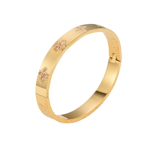 Gold stainless steel hinged bangle featuring sparkling zircon flower clover patterns