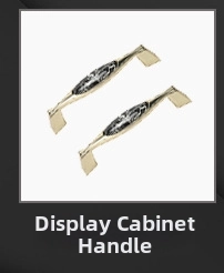 Detailed view of elegant gold streamline cabinet handles with ornate hollowed-out centers