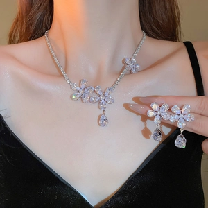 Sparkling crystal flower necklace and earring set worn by a model for a luxury jewelry look