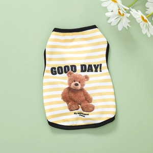 Macro shot of yellow striped dog vest with mesh fabric, teddy bear, and Good Day print
