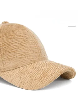 Detail of khaki corduroy baseball cap with foldable wide brim and ribbed texture