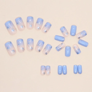 Blue butterfly square false nails with glitter gradient design on beige background