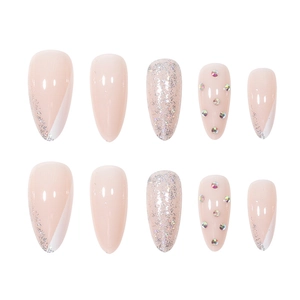 Almond shaped nude pink almond press-on nails with silver glitter and rhinestone accents