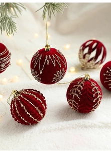 Detailed close-up of 8cm burgundy flocked Christmas balls with gold sequins and embroidery