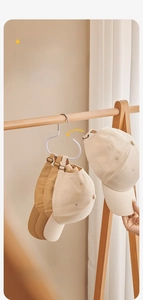Macro detail of the large opening white storage hook for baseball caps and scarves