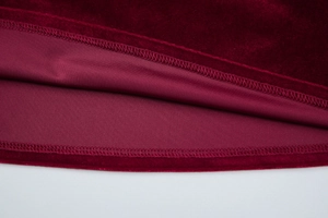 Detailed close-up of wine red velvet fabric showing precise double-stitch sewing and lining