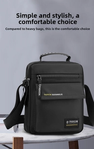 Detail of black nylon messenger bag featuring top handle and adjustable shoulder strap