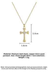 Detail of a gold cross pendant measuring 3.4x1.8cm with micro-inlaid sparkling zircons
