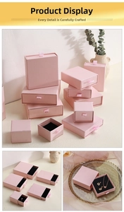Detailed view of pink drawer jewelry boxes with black velvet liners in various sizes