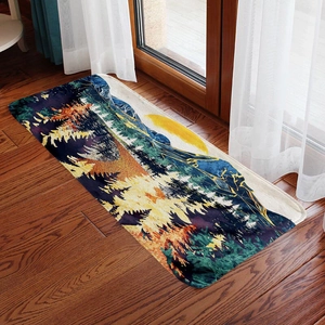 Absorbent flannel mountain print floor mat with forest and sun design on wood floor